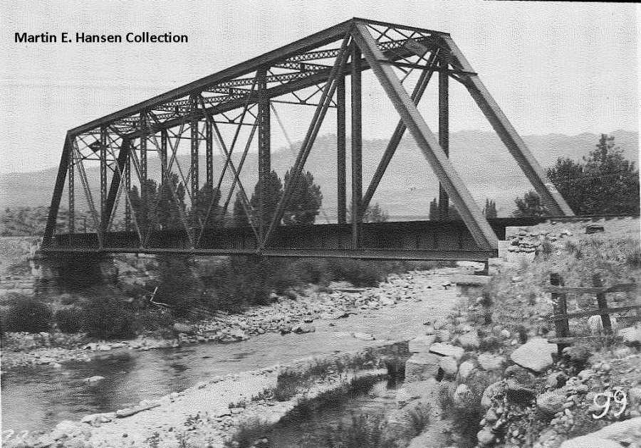 a train crossing a bridge over a body of water