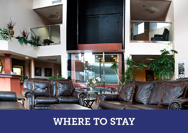 a living room filled with furniture and a large window