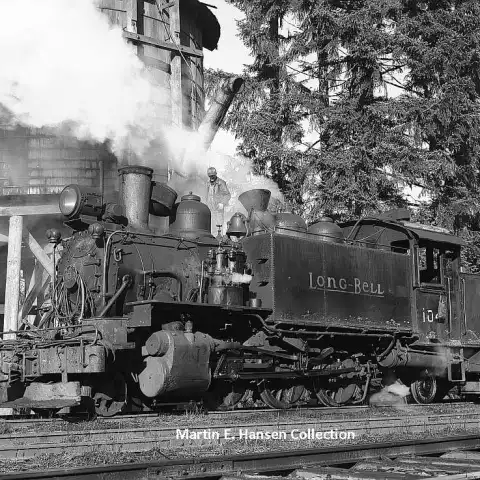 a steam engine train traveling down train tracks
