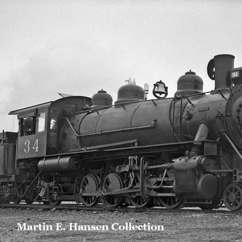 a steam engine is sitting on a train track